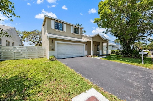 14480 SW 145th Pl, Miami, FL 33186 - view of front facade with stucco siding, asphalt driveway, and a garage