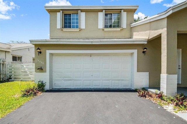 14480 SW 145th Pl, Miami, FL 33186 - view of front of home with stucco siding, a garage, driveway, and fence