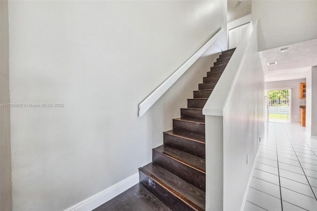 14480 SW 145th Pl, Miami, FL 33186 - staircase featuring baseboards and tile patterned floors