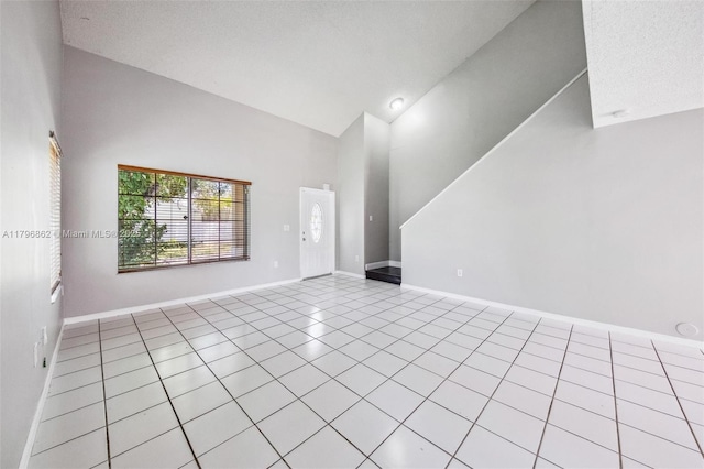 14480 SW 145th Pl, Miami, FL 33186 - unfurnished living room with high vaulted ceiling, tile patterned flooring, and baseboards