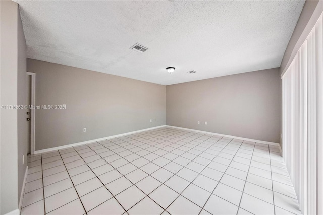 14480 SW 145th Pl, Miami, FL 33186 - empty room featuring baseboards, a textured ceiling, and light tile patterned floors