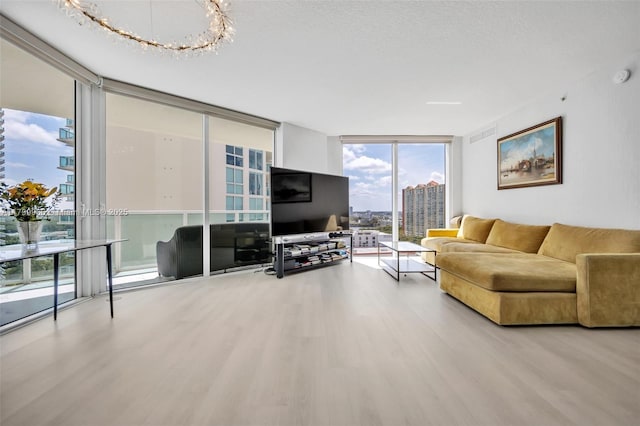 200 Sunny Isles Blvd Unit 2-1503, Sunny Isles Beach, FL 33160 - living room featuring a wall of windows, wood finished floors, and a chandelier