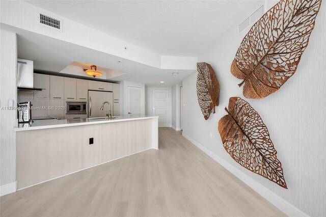 200 Sunny Isles Blvd Unit 2-1503, Sunny Isles Beach, FL 33160 - kitchen with appliances with stainless steel finishes, wall chimney range hood, light wood-style floors, and baseboards