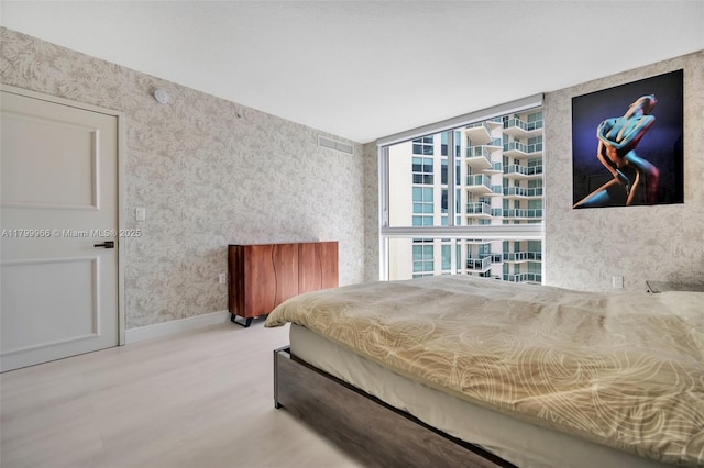 200 Sunny Isles Blvd Unit 2-1503, Sunny Isles Beach, FL 33160 - bedroom featuring wallpapered walls, wood finished floors, and baseboards