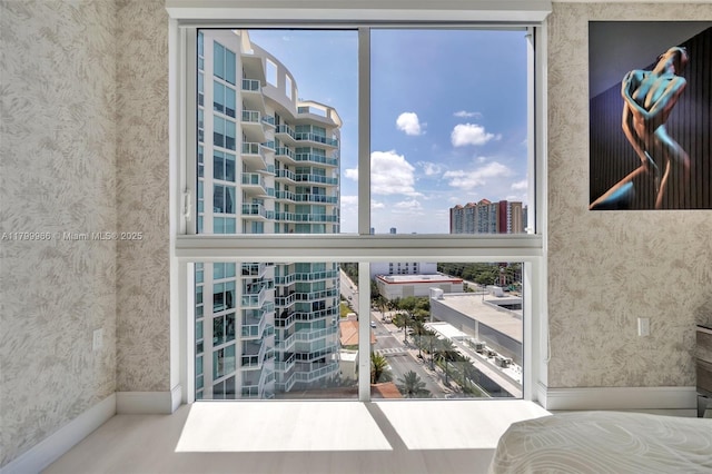detailed view of wallpapered walls, baseboards, and a city view