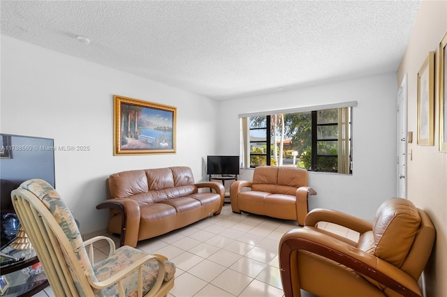 living room with a textured ceiling and light tile patterned floors