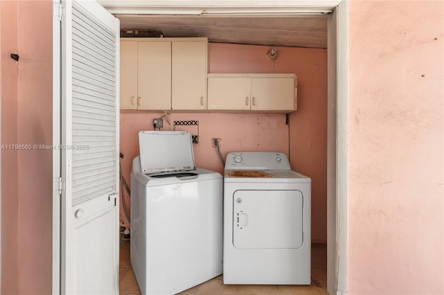 laundry room with separate washer and dryer, cabinet space, and light tile patterned flooring
