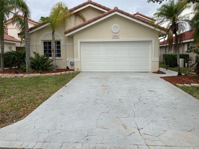 17691 SW 4th Ct, Pembroke Pines, FL 33029 - mediterranean / spanish house with concrete driveway, a garage, stucco siding, and a tile roof
