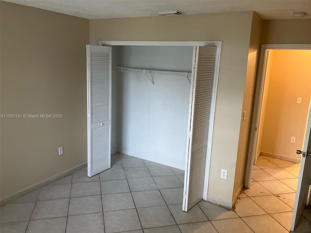 17691 SW 4th Ct, Pembroke Pines, FL 33029 - unfurnished bedroom with a closet, light tile patterned floors, and baseboards