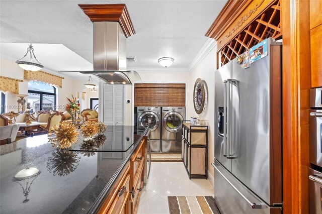 13111 NW 11th Ter, Miami, FL 33182 - kitchen with high quality fridge, washer and clothes dryer, crown molding, light tile patterned floors, and dark stone counters