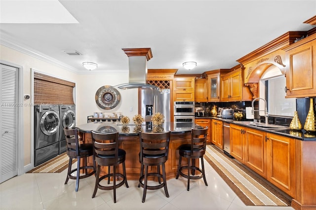 13111 NW 11th Ter, Miami, FL 33182 - kitchen featuring washing machine and clothes dryer, appliances with stainless steel finishes, a sink, dark countertops, and crown molding