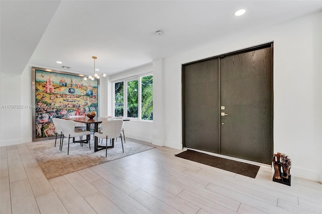 515 NE 115th St, Biscayne Park, FL 33161 - dining space with a chandelier, light wood finished floors, baseboards, and recessed lighting
