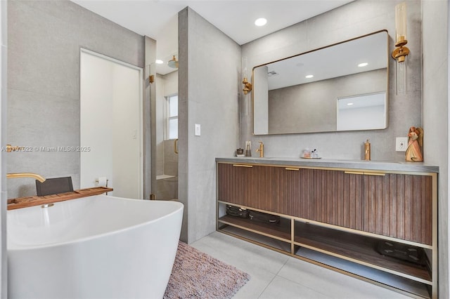 515 NE 115th St, Biscayne Park, FL 33161 - full bath with double vanity, a soaking tub, a stall shower, tile patterned flooring, and tile walls