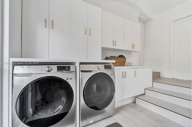 515 NE 115th St, Biscayne Park, FL 33161 - laundry room featuring independent washer and dryer, cabinet space, and light wood-type flooring