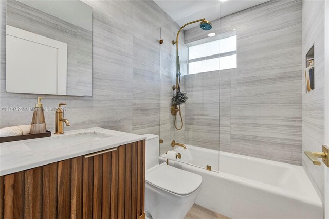 515 NE 115th St, Biscayne Park, FL 33161 - bathroom featuring toilet,  shower combination, vanity, and tile walls