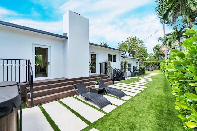 515 NE 115th St, Biscayne Park, FL 33161 - rear view of property featuring a patio, stucco siding, a lawn, and a chimney