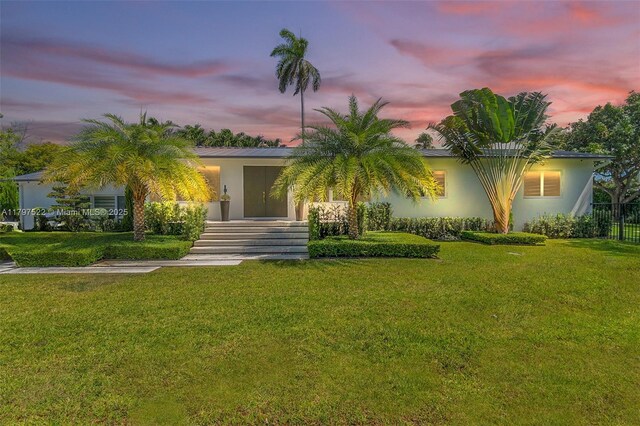 515 NE 115th St, Biscayne Park, FL 33161 - view of front of home with a front lawn and stucco siding