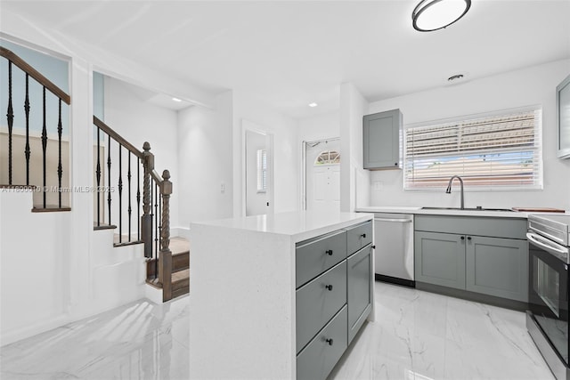 450 SE 7th St Unit 214, Dania Beach, FL 33004 - kitchen with gray cabinetry, a sink, stainless steel appliances, a center island, and recessed lighting