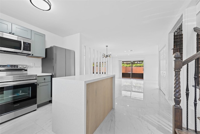 450 SE 7th St Unit 214, Dania Beach, FL 33004 - kitchen with appliances with stainless steel finishes, light marble finish flooring, gray cabinetry, light countertops, and a chandelier
