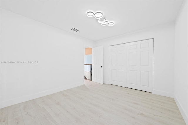 450 SE 7th St Unit 214, Dania Beach, FL 33004 - unfurnished bedroom with wood finished floors, baseboards, and a closet