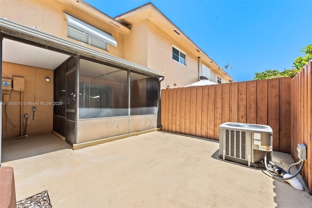 450 SE 7th St Unit 214, Dania Beach, FL 33004 - view of patio / terrace featuring fence, central AC unit, and a sunroom