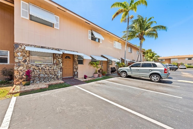 450 SE 7th St Unit 214, Dania Beach, FL 33004 - view of front of home featuring uncovered parking and stone siding