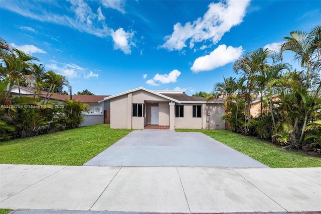 19231 SW 121st Ave, Miami, FL 33177 - view of front of home featuring a front lawn, stucco siding, and concrete driveway