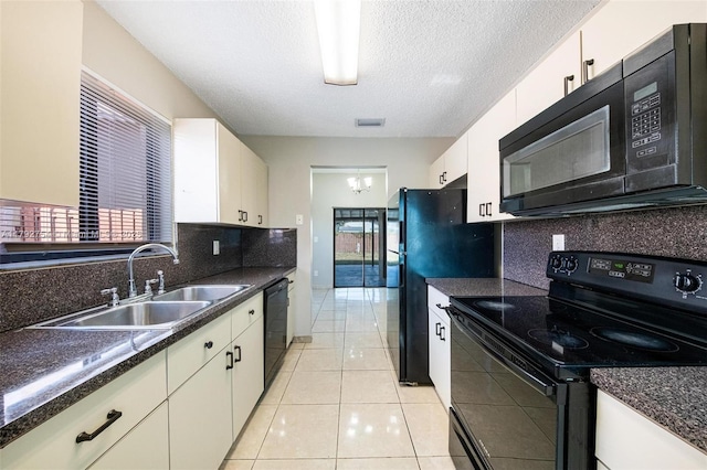19231 SW 121st Ave, Miami, FL 33177 - kitchen with black appliances, a sink, dark countertops, backsplash, and white cabinetry