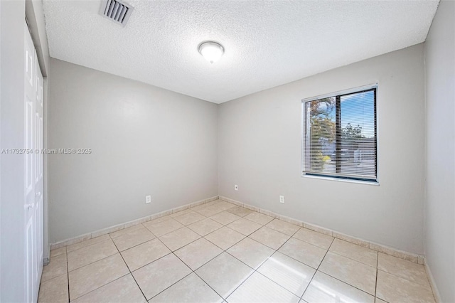 19231 SW 121st Ave, Miami, FL 33177 - unfurnished room featuring light tile patterned flooring, a textured ceiling, and baseboards