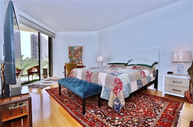 bedroom featuring crown molding and wood finished floors