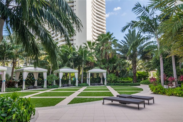 surrounding community with a gazebo and a yard
