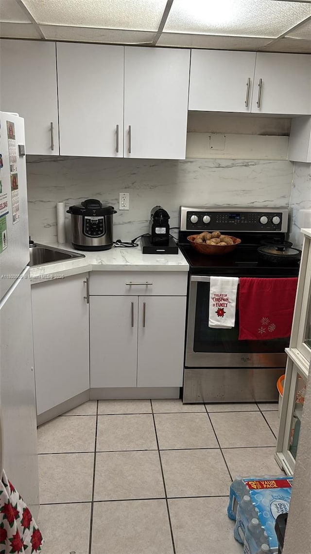 801 NW 47th Ave Unit 503W, Miami, FL 33126 - kitchen featuring stainless steel electric range, freestanding refrigerator, and white cabinets