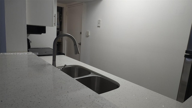 1720 NW N River Dr Unit 113, Miami, FL 33125 - kitchen featuring a sink, white cabinets, and light stone counters