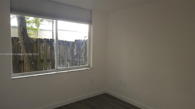 1720 NW N River Dr Unit 113, Miami, FL 33125 - empty room with baseboards and dark wood-style flooring