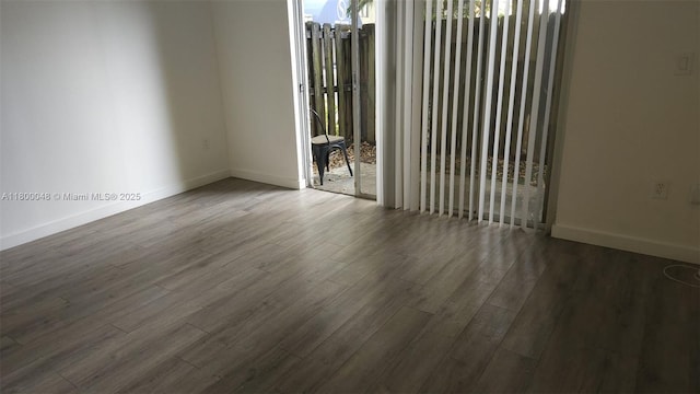 1720 NW N River Dr Unit 113, Miami, FL 33125 - empty room featuring wood finished floors, baseboards, and plenty of natural light