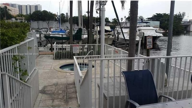 1720 NW N River Dr Unit 113, Miami, FL 33125 - view of patio / terrace featuring a water view and a hot tub