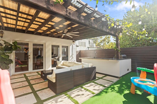 2924 Bridgeport Ave, Miami, FL 33133 - view of patio with an outdoor hangout area, french doors, a ceiling fan, fence, and a bar