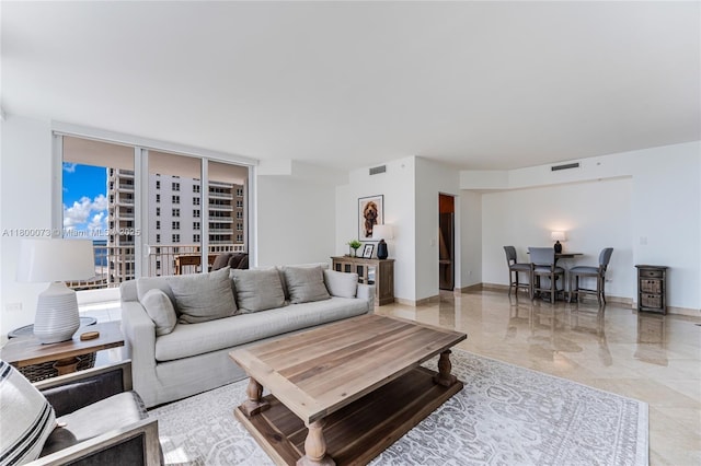 living area featuring baseboards and light marble finish flooring