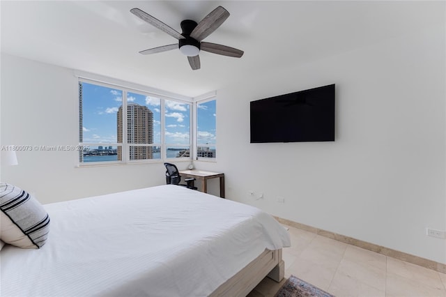 bedroom featuring ceiling fan and baseboards