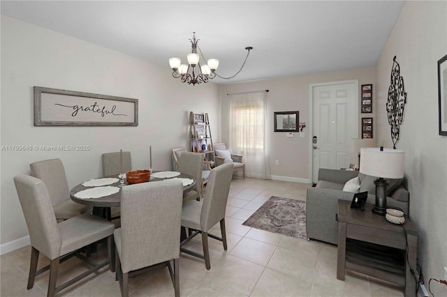8897 SW 229th St, Cutler Bay, FL 33190 - dining room with a chandelier, light tile patterned floors, and baseboards