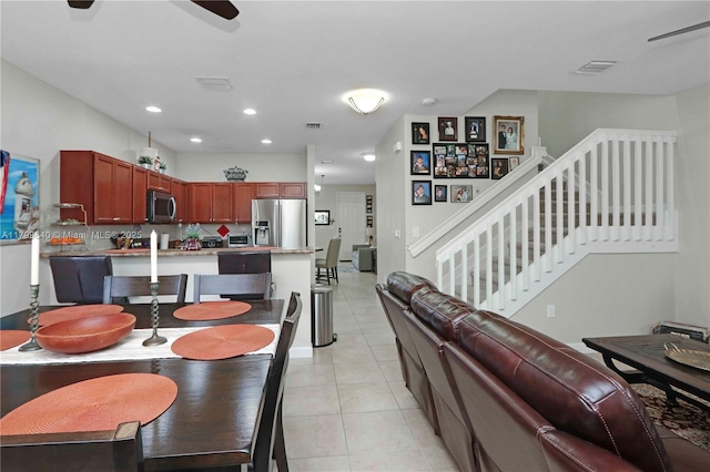 8897 SW 229th St, Cutler Bay, FL 33190 - dining space with light tile patterned floors, a ceiling fan, recessed lighting, and stairs
