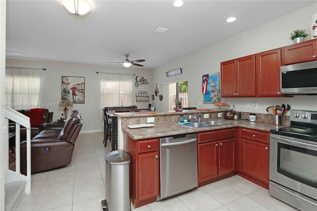8897 SW 229th St, Cutler Bay, FL 33190 - kitchen with stainless steel appliances, a sink, open floor plan, a peninsula, and a ceiling fan