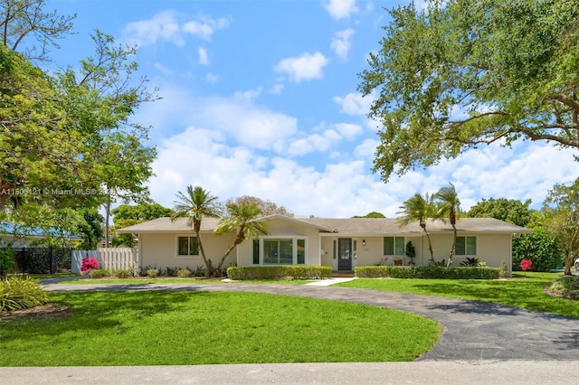 single story home featuring curved driveway and stucco siding