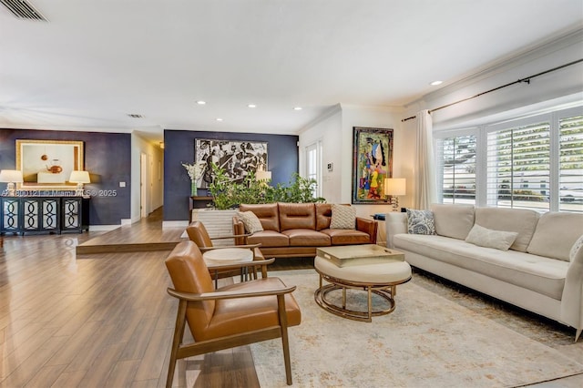 living room featuring crown molding, wood finished floors, recessed lighting, and baseboards