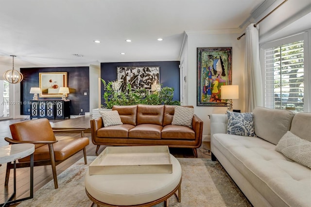 living area featuring wood finished floors, ornamental molding, recessed lighting, baseboards, and a chandelier