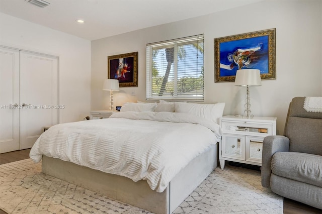 bedroom featuring wood finished floors and recessed lighting