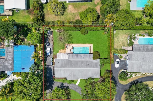 aerial view of property and surrounding area featuring a pool area and property boundaries highlighted