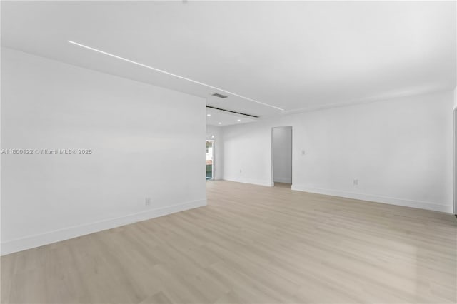 empty room featuring light wood-style floors, baseboards, and recessed lighting