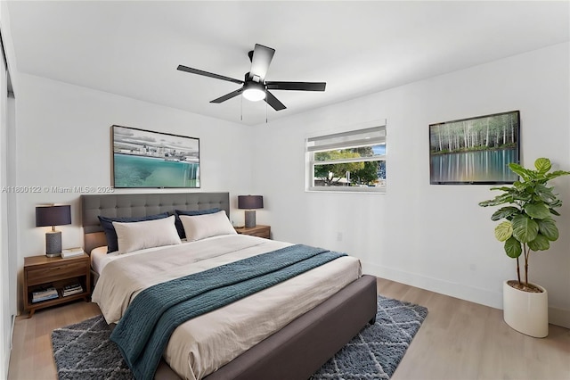 bedroom with wood finished floors, ceiling fan, and baseboards