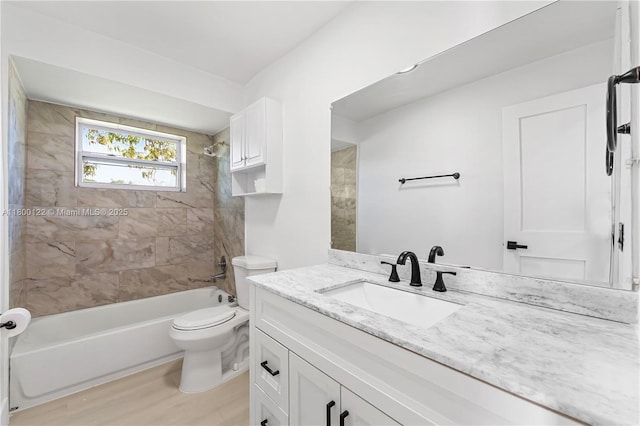 bathroom featuring toilet, shower / bath combination, vanity, and wood finished floors